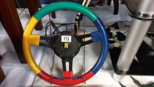 A Renault multi coloured steering wheel Diameter 33cm approximately