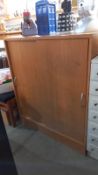 A pine effect office cupboard 94cm x 40cm x 104cm