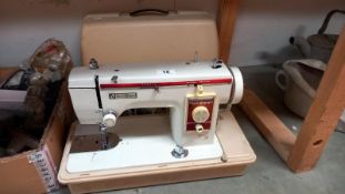 A cased New Home sewing machine. COLLECT ONLY
