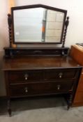 A 1930's oak mirror back dressing table. 107cm x 50cm x 82cm high, mirror 153cm