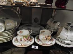 An 18 piece teaset, 12 piece teaset large cake platter and 2 cups and saucers