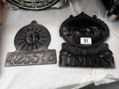 A replica metal fire mark and one other