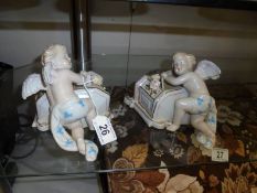 A pair of porcelain cherub wall pockets.