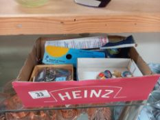 A box of space related pens, badges & key rings