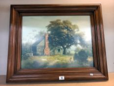A large dark wood framed print of a log cabin under a tree