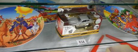 A boxed Corgi Casino Royale Aston Martin DB5 and four McDonalds 1998 melamine plates.