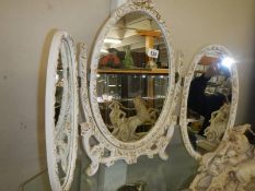 An ormolu style tripal oval framed dressing table mirror. COLLECT ONLY.