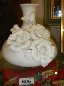 A bisque bulbous vase decorated with flowers, 20cm tall.