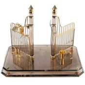 A SOLID GOLD, DIAMOND AND ROCK CRYSTAL ORNAMENT DEPICTING THE ENTRANCE TO STABLES WITH RIDING AND