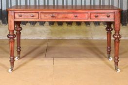 A Victorian mahogany writing table by Heal & Son,