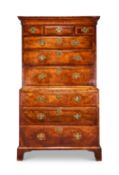A George I walnut feather banded and crossbanded chest on chest