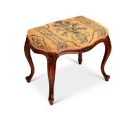 A mid 19th century Louis XV style walnut carved stool