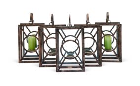 A set of five antiqued metal hanging mirror backed candle holders