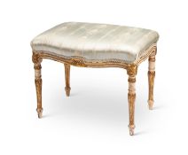 A George III white painted and parcel gilt serpentine stool