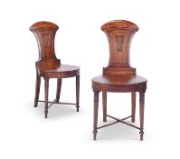 A pair of late George IV / Regency mahogany hall chairs