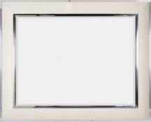 A large contemporary cream suede and chrome mirror