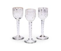 A set of three George III facet cut gilded wine or cordial glasses, circa 1780