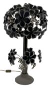 A gun metal and plastic tree two-light lamp with flowerhead decoration