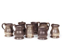 Eight 18th century pewter baluster pint tankards