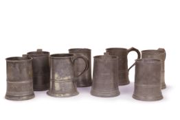Seven 18th century pewter quart handled tankards