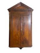 A George I style walnut hanging corner cupboard