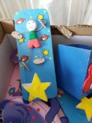 Box of pink and blue door and clothes hooks and mirrors for children's rooms