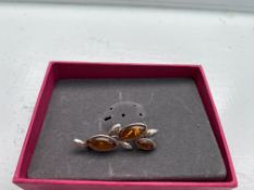 Silver and amber brooch