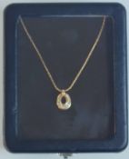 A Christian Dior Gold Tone Necklace With Pendant. The Pendant Has White Stones.