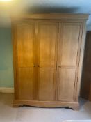 A light oak triple wardrobe (H222cm W162cm D60cm)