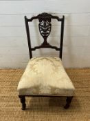A Victorian trophy pierced back nursing chair (H77cm)