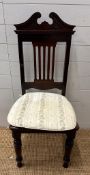 An Edwardian style mahogany hall chair with carved relief and turned front legs
