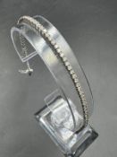 An 18ct white gold Tennis or line bracelet set with approximately 3ct of diamonds.