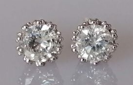 A pair of single stone diamond stud earrings