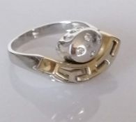A cubic zirconia dress ring, the four central round brilliant cubic zirconias set in white metal
