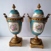 A pair of 19th century Sèvres twin-handle ormolu decorated garniture lidded urns