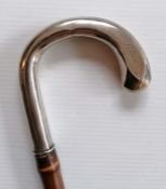 An early 20th century bamboo root sword stick with faceted 830 silver-topped handle