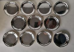 A set of eleven 800 silver coasters with wavy rims, each 11 cm diameter, 586g