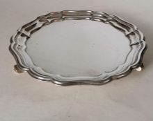 A George VI silver salver with pie crust border on three scroll feet by Garrard, London, 1945, 20 cm