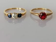 A three-stone sapphire and diamond ring the central diamond approximately 0.30 carats
