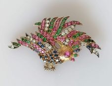 A diamond, ruby, sapphire and emerald bird brooch on a yellow gold frame, 33 x 56mm