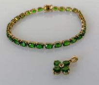 An emerald and gold line or tennis bracelet, 19 cm, with matching pendant, hallmarked 9ct, 9.3g (2)