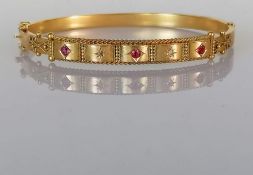 A late Victorian Etruscan-style ruby and diamond hinged gold bangle, interior 65mm W, hallmarked 9ct