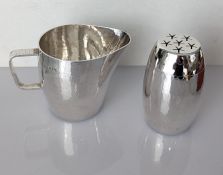 A contemporary silver cream jug with bark-effect handle, planished body, 7.5 cm H and