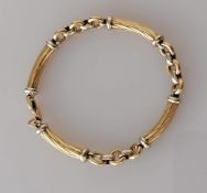 A yellow and white gold bracelet with rope-twist baton links and lobster clasp, Egyptian hallmarks