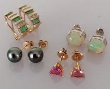 A pair of oval cabochon opal earrings on a platinum claw setting, each opal 10 x 8mm