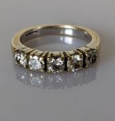 An 18ct white gold diamond ring comprising five round brilliant-cut diamonds in a claw setting