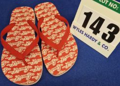 A Pair of LOUIS VUITTON Molitor Men's Red Rubber Flip Flop Sandals with White 'Louis V' Signature