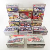 12 NASCAR Car Model Kits & 1 Display Case