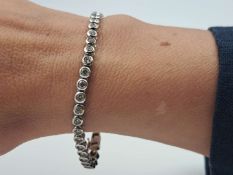 A Diamond & 18ct, white gold “Tennis” bracelet