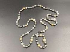 SCHOEFFEL, a signed, single strand of colored freshwater pearls.